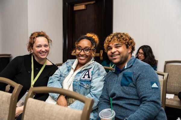 A group of attendees smile while in a concurrent session